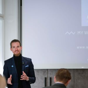 Thomas Payr, CMO von Alps Resorts, bei einer Präsentation vor Publikum.