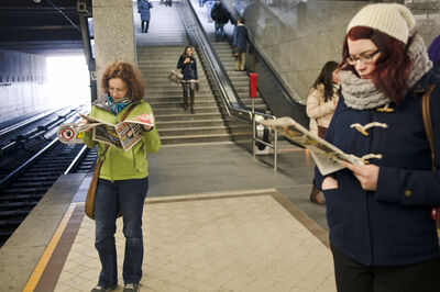 "Vienna, Austria - March 12, 2013: People are on the metro station two woman reading while waiting their trains."