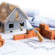 project with brick and blueprint on white