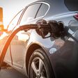 Person pumping gas. Fuel petrol for car at gasoline oil station nozzle in tank. Hand and black refueling gun close-up