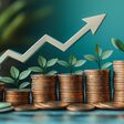 A graph with an arrow pointing upwards, growing coins and green leaves on the side of each column. The background is light blue, the arrow has white edges. There's money under it, symbolizing growth in finance or business success.