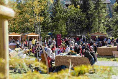stehende und sitzende Besucher des neuen Dorfplatzes in Bad Kleinkirchheim, Kärnten