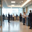 KI-generiert: verschwommene Ansicht eines Bank-Foyers mit mehreren Computern und Menschen