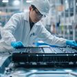 Chinese engineer working on EV car battery cells module in a electric vehicle factory
